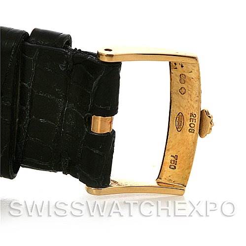 The image shows a close-up of a Rolex Cellini 4233 Yellow Gold White Dial 4233 Yellow Gold White Dial watch's gold buckle and part of its black leather strap.