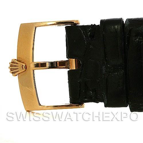 This image features the gold buckle and part of the black leather strap of a Rolex Cellini 4233 Yellow Gold White Dial 4233 Yellow Gold White Dial watch.