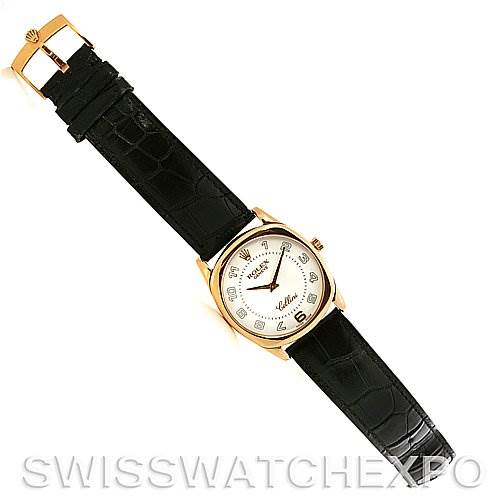 The image shows a top-down view of a Rolex Cellini 4233 Yellow Gold White Dial 4233 Yellow Gold White Dial watch with a black leather strap and a gold case.