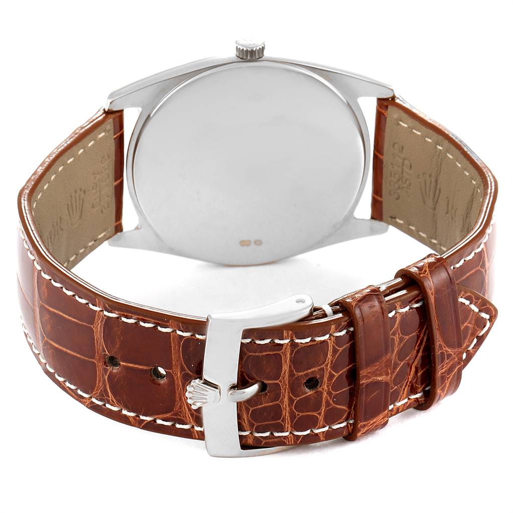 The image shows the underside of a Rolex Cellini 4233 Men's White Gold Black Dial 4233 Men's White Gold Black Dial model, highlighting its leather strap and metal buckle.