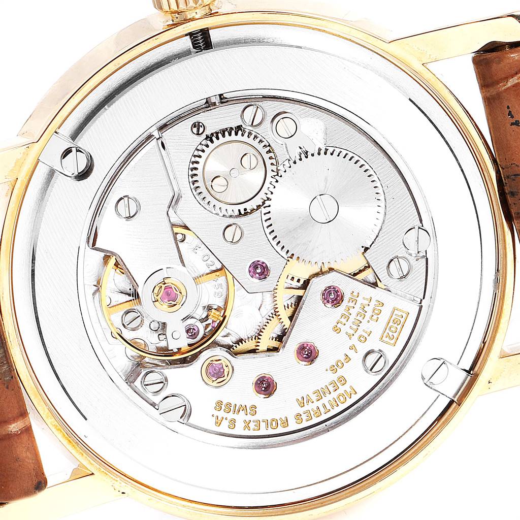 This image shows the back view of the Rolex Cellini 5115 Men's Yellow Gold Beige Dial 5115 Men's Yellow Gold Beige Dial watch, highlighting its intricate internal mechanical movements.