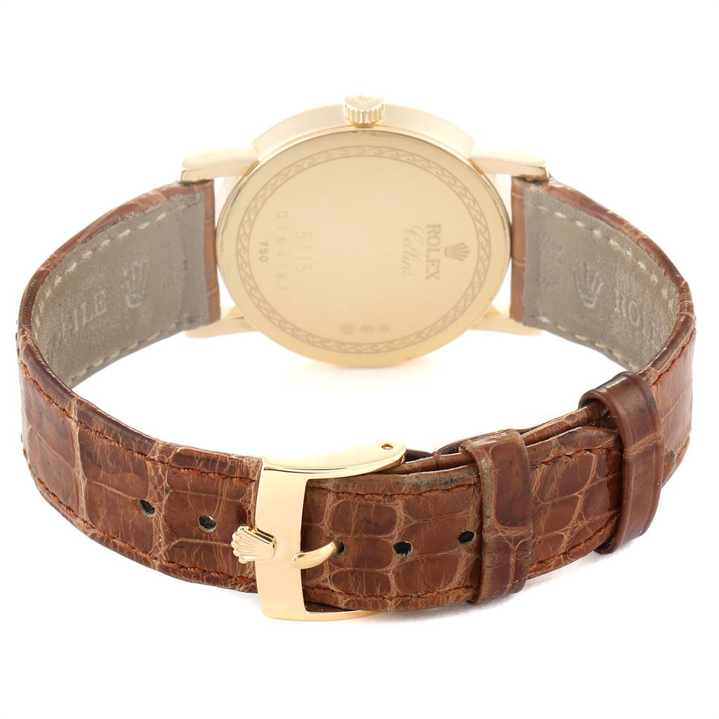 The image shows the back of the Rolex Cellini 5115 Men's Yellow Gold Beige Dial 5115 Men's Yellow Gold Beige Dial watch with a brown leather strap and gold clasp.