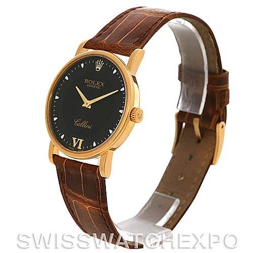 The Rolex Cellini 5115 Yellow Gold Black Dial 5115 Yellow Gold Black Dial watch is shown at a three-quarter angle, displaying its black dial, gold case, and brown leather strap.