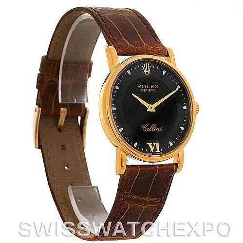 The Rolex Cellini 5115 Yellow Gold Black Dial 5115 Yellow Gold Black Dial watch is shown at a slight angle, displaying its black dial, gold case, and brown leather strap.
