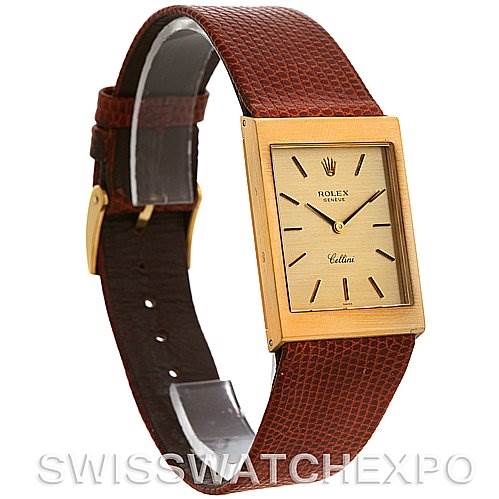 This image shows a Rolex Cellini 4027 Men
s Yellow Gold Champagne Dial 4027 Men
s Yellow Gold Champagne Dial watch from an angled side view, featuring a rectangular gold case and a brown leather strap.