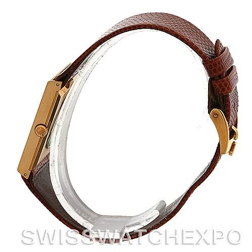 This side view of a Rolex Cellini 4027 Men
s Yellow Gold Champagne Dial 4027 Men
s Yellow Gold Champagne Dial watch shows the brown leather strap, the gold case, and the crown.