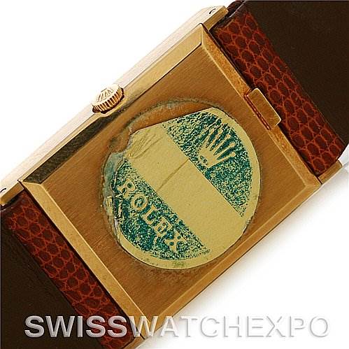 The image shows the back of a Rolex Cellini 4027 Men
s Yellow Gold Champagne Dial 4027 Men
s Yellow Gold Champagne Dial watch, specifically highlighting the case back, crown, and part of the strap.