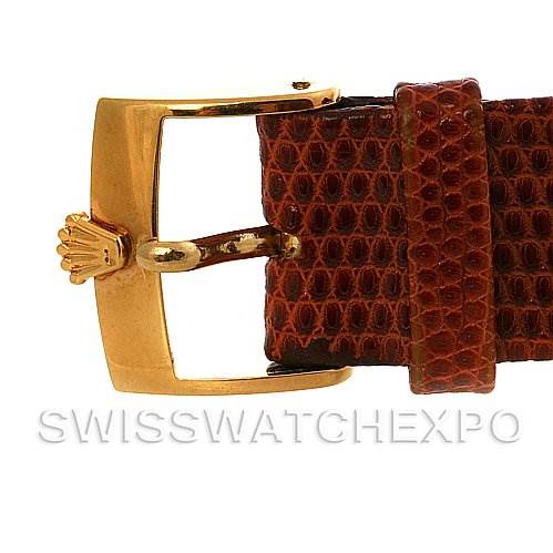 The image shows a close-up of the buckle and part of the leather strap of a Rolex Cellini 4027 Men
s Yellow Gold Champagne Dial 4027 Men
s Yellow Gold Champagne Dial watch.