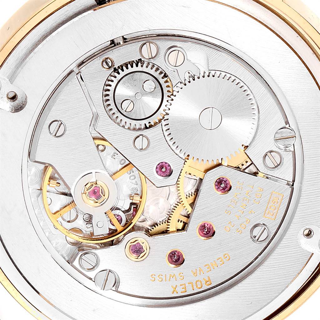 This image shows the intricate internal movement mechanism of a Rolex Cellini 5115 Men's Yellow Gold Beige Dial 5115 Men's Yellow Gold Beige Dial watch from a close-up angle.