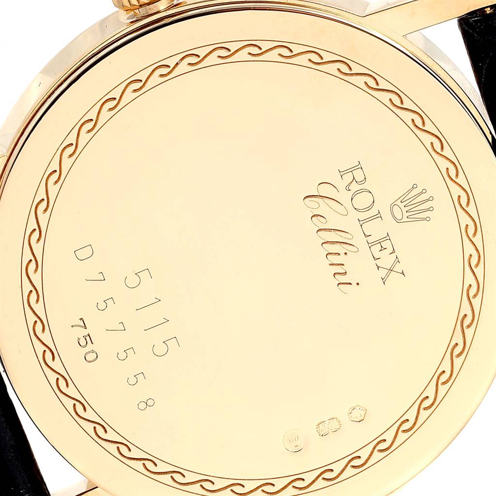 The image shows the back case of a Rolex Cellini 5115 Men's Yellow Gold Beige Dial 5115 Men's Yellow Gold Beige Dial watch, highlighting its engravings and gold finish.