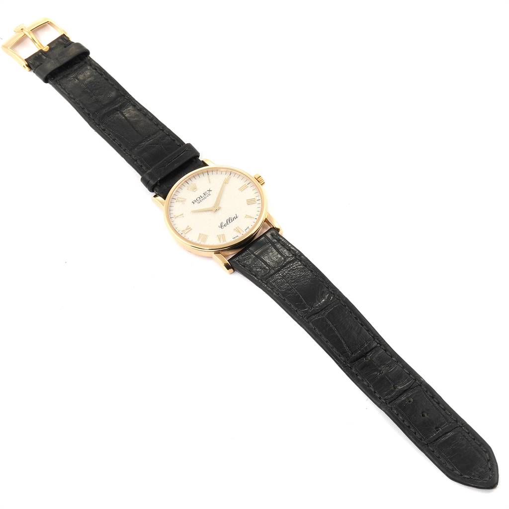 The Rolex Cellini 5115 Men's Yellow Gold Beige Dial 5115 Men's Yellow Gold Beige Dial watch is shown from a top-down angle, displaying the full leather strap and dial.