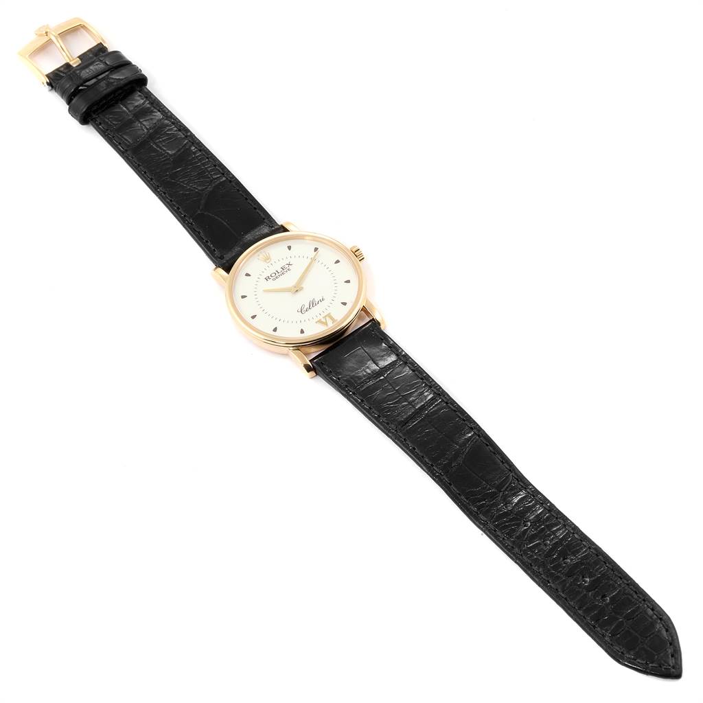 The image shows a top-down view of a Rolex Cellini 5115 Men's Yellow Gold Silver Dial 5115 Men's Yellow Gold Silver Dial watch featuring a black leather strap and gold case.