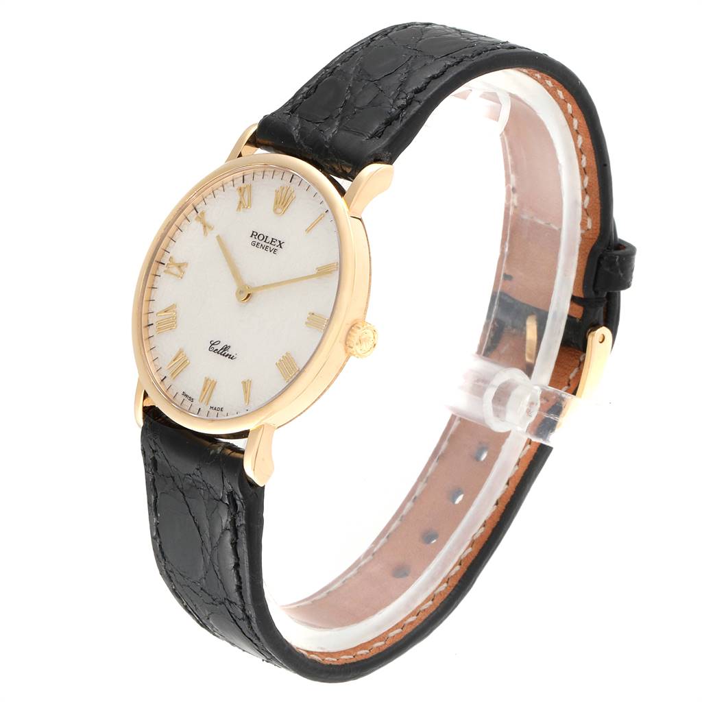 The Rolex Cellini 5112 Men's Yellow Gold Beige Dial 5112 Men's Yellow Gold Beige Dial watch is shown at an angle displaying its face, black leather strap, gold case, and crown.