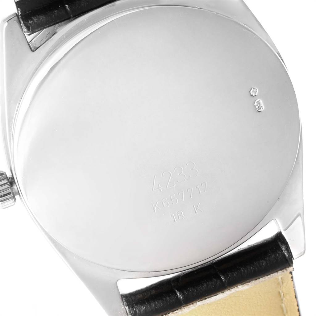 The image shows the back of a Rolex Cellini 4233 Men's White Gold Black Dial 4233 Men's White Gold Black Dial watch, displaying its serial number and 18K gold mark.