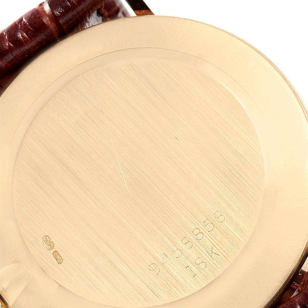 The image shows the back case of a Rolex Cellini 4112 Men's Yellow Gold Silver Dial 4112 Men's Yellow Gold Silver Dial watch, highlighting its 18K gold material and serial number.