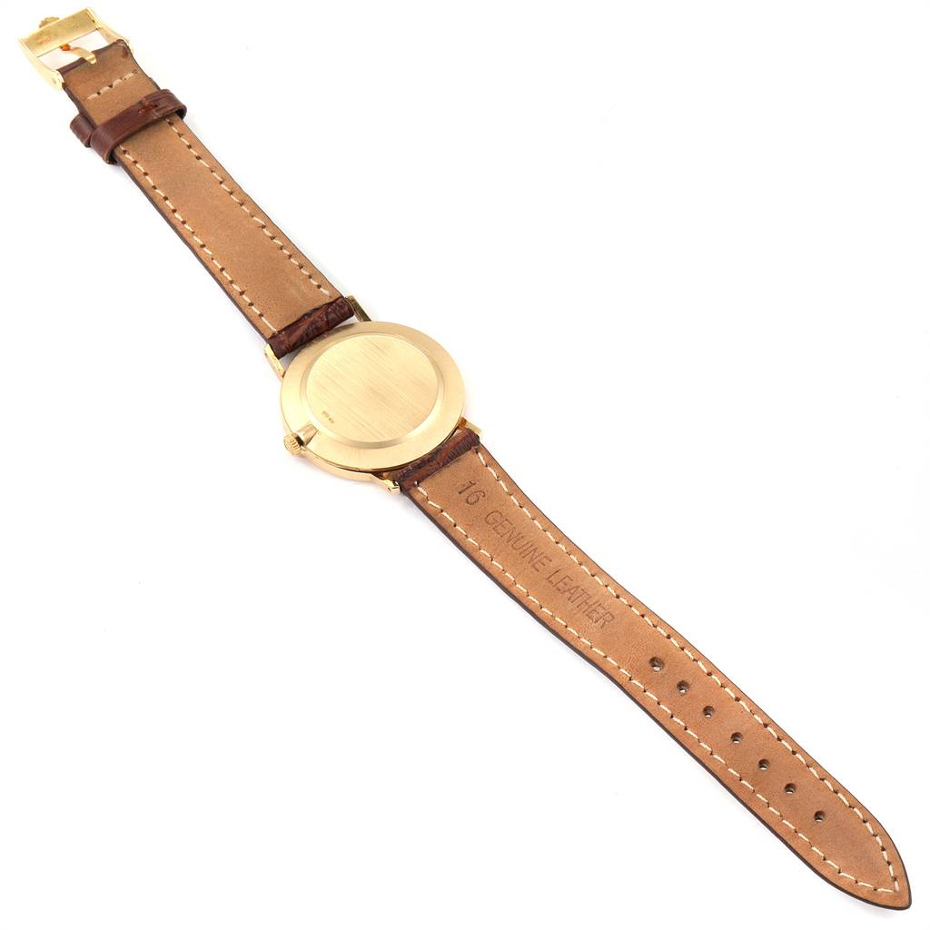 The image shows the back view of a Rolex Cellini 4112 Men's Yellow Gold Silver Dial 4112 Men's Yellow Gold Silver Dial watch, revealing its leather strap and the case back.