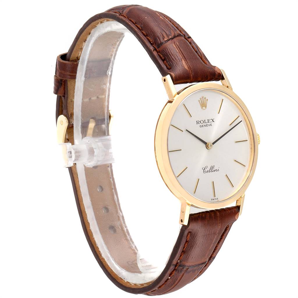 The Rolex Cellini 4112 Men's Yellow Gold Silver Dial 4112 Men's Yellow Gold Silver Dial watch is shown at a side angle, displaying its brown leather strap, gold case, and white dial.