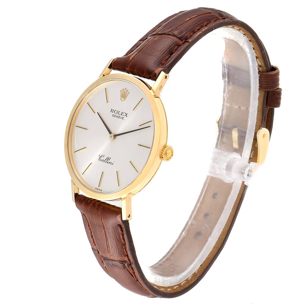The Rolex Cellini 4112 Men's Yellow Gold Silver Dial 4112 Men's Yellow Gold Silver Dial watch is shown at a three-quarter angle, displaying the dial, case, crown, and brown leather strap.
