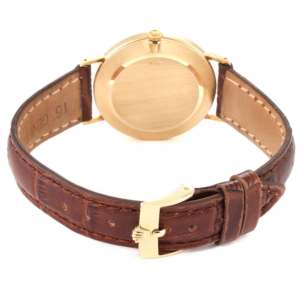 This image shows the back view of a Rolex Cellini 4112 Men's Yellow Gold Silver Dial 4112 Men's Yellow Gold Silver Dial watch, highlighting its leather strap, gold case back, and buckle.