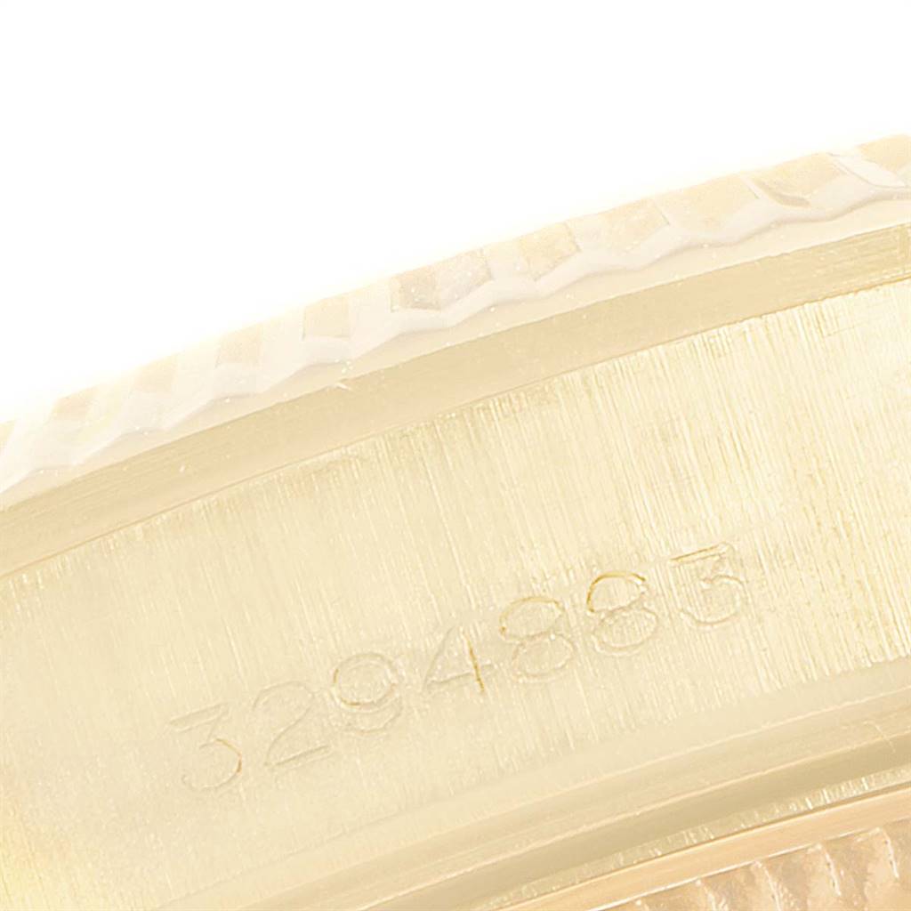 This image shows a close-up of the side of a Rolex Cellini 1503 Men's Yellow Gold Champagne Dial 1503 Men's Yellow Gold Champagne Dial watch case, displaying a part of the serial number and details of the bezel.