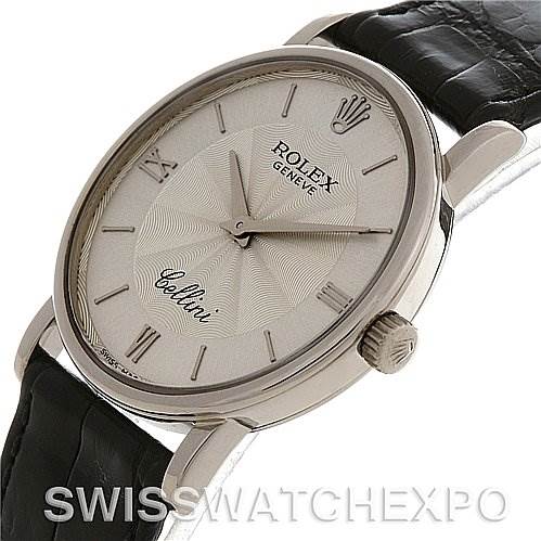 The Rolex Cellini 5115/9 White Gold Silver Dial 5115/9 White Gold Silver Dial watch is shown at a slightly tilted angle, highlighting the dial, crown, and leather strap.