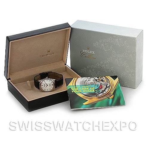 The image shows a Rolex Cellini 4233 White Gold White Dial 4233 White Gold White Dial watch in its open box alongside a brochure and its outer packaging.