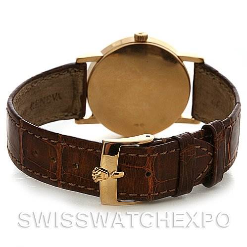 The Rolex Cellini 5115 Yellow Gold White Dial 5115 Yellow Gold White Dial watch is shown from the back, displaying its case, crown, and leather strap with a gold buckle.