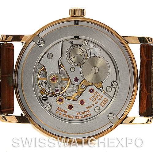 The image shows the back view of a Rolex Cellini 5115 Yellow Gold White Dial 5115 Yellow Gold White Dial watch, displaying its intricate mechanical movement.