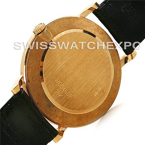 The image shows the back case of a Rolex Cellini 5112 Yellow Gold Beige Dial 5112 Yellow Gold Beige Dial watch, highlighting its gold finish and black leather strap.