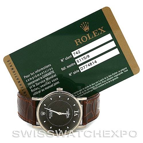 The image shows a front view of the Rolex Cellini 5115 White Gold Brown Dial 5115 White Gold Brown Dial watch with its green warranty card behind it.