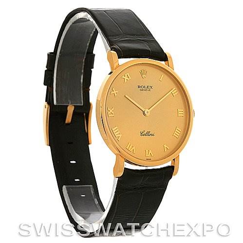 This image shows a Rolex Cellini 5112 Men's Yellow Gold Champagne Dial 5112 Men's Yellow Gold Champagne Dial watch from an angled side view, featuring its golden dial, Roman numerals, and black leather strap.