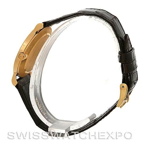 Side view of a Rolex Cellini 5112 Yellow Gold  5112 Yellow Gold  watch showing the case, crown, and black leather strap clasped with a gold buckle.