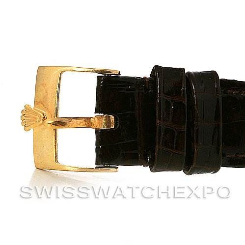 The image shows a close-up view of the gold buckle and black leather strap of a Rolex Cellini 5112 Yellow Gold  5112 Yellow Gold  watch.