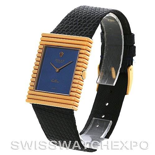 The image shows the Rolex Cellini 4012 Men
s Yellow Gold Blue Dial 4012 Men
s Yellow Gold Blue Dial watch at a side angle, highlighting its rectangular gold case, blue dial, and black textured strap.