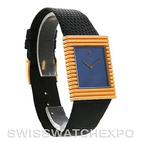 This image shows a Rolex Cellini 4012 Men
s Yellow Gold Blue Dial 4012 Men
s Yellow Gold Blue Dial watch with a rectangular gold case, blue dial, and black leather strap from an angled side view.