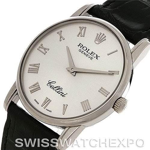 The image shows a Rolex Cellini 5116/9 White Gold Silver Dial 5116/9 White Gold Silver Dial watch at an angle, highlighting its white dial, Roman numerals, and leather strap.