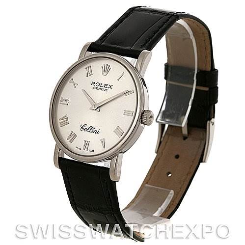 The Rolex Cellini 5115 White Gold Silver Dial 5115 White Gold Silver Dial watch is shown at a tilted angle, displaying its face, case, crown, and leather strap.