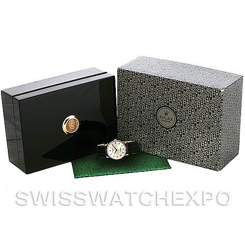 The image shows a Rolex Cellini 5115 White Gold Silver Dial 5115 White Gold Silver Dial watch with its packaging, including a black box, patterned outer box, and a green document.