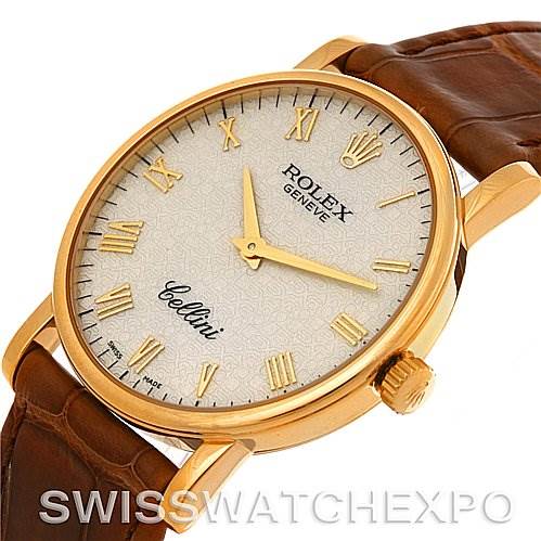 The Rolex Cellini 5115 Men's Yellow Gold Beige Dial 5115 Men's Yellow Gold Beige Dial watch is shown at a slight angle, highlighting the dial, crown, case, and leather strap.