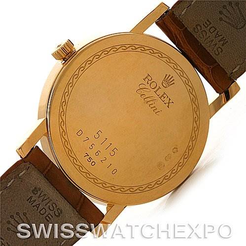 The image shows the back case of a Rolex Cellini 5115 Men's Yellow Gold Beige Dial 5115 Men's Yellow Gold Beige Dial watch, featuring engravings and the attached leather straps.