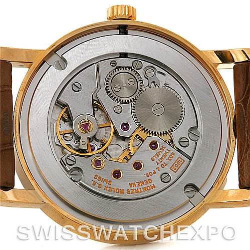 This image shows the back view of a Rolex Cellini 5115 Men's Yellow Gold Beige Dial 5115 Men's Yellow Gold Beige Dial watch, highlighting its intricate mechanical movement and components.