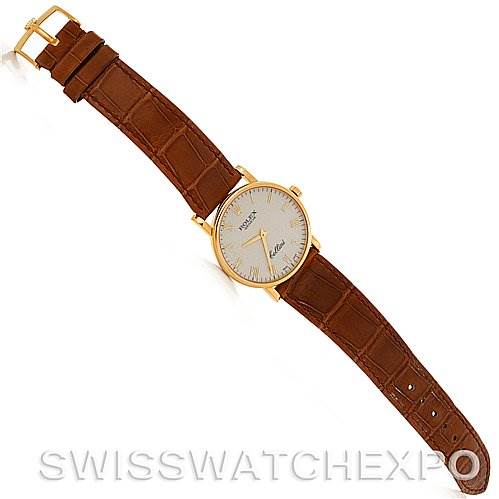 This is a top-down view of a Rolex Cellini 5115 Men's Yellow Gold Beige Dial 5115 Men's Yellow Gold Beige Dial watch showing its round gold case, cream dial, and brown leather strap.