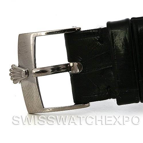 This image shows a close-up of the buckle and part of the leather strap of a Rolex Cellini 5116 White Gold Black Dial 5116 White Gold Black Dial watch.