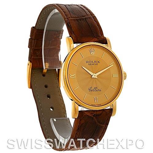The Rolex Cellini 5115 Men's Yellow Gold Champagne Dial 5115 Men's Yellow Gold Champagne Dial watch is shown at a slight angle, highlighting the brown leather strap and gold round dial with Roman numeral markers.