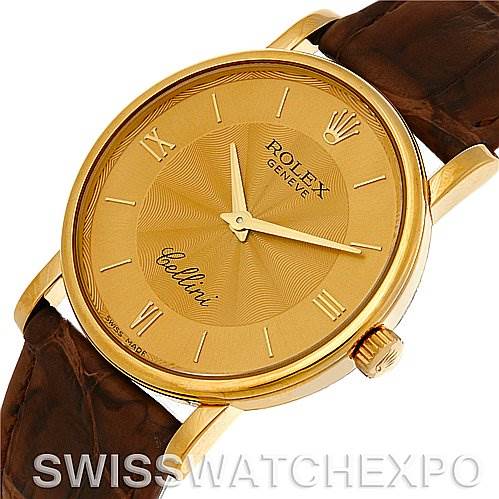 This is a close-up view of the Rolex Cellini 5115 Men's Yellow Gold Champagne Dial 5115 Men's Yellow Gold Champagne Dial watch showing the face, bezel, crown, and part of the leather strap.