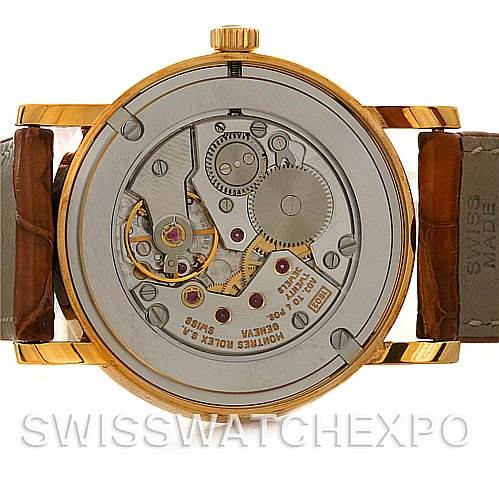 The image shows a Rolex Cellini 5115 Men's Yellow Gold Champagne Dial 5115 Men's Yellow Gold Champagne Dial watch from the back, highlighting its intricate movement and internal components.