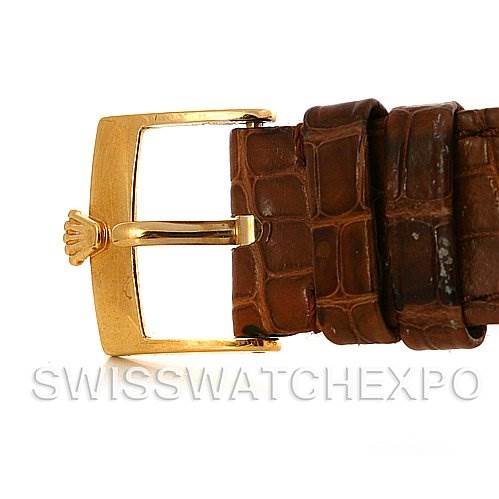 The image shows a close-up of the brown leather strap and gold buckle of a Rolex Cellini 5115 Men's Yellow Gold Champagne Dial 5115 Men's Yellow Gold Champagne Dial watch.