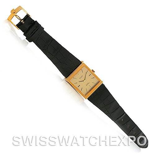 This image shows a top-down view of a Rolex Cellini 4014 Men's Yellow Gold Champagne Dial 4014 Men's Yellow Gold Champagne Dial watch, featuring its black leather strap and rectangular gold case.