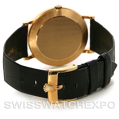 The image shows the back view of a Rolex Cellini 5112 Men's Yellow Gold Mother of Pearl Dial 5112 Men's Yellow Gold Mother of Pearl Dial watch, highlighting its gold case back and black leather strap with a gold buckle.