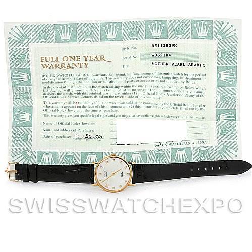 This image shows a Rolex Cellini 5112 Men's Yellow Gold Mother of Pearl Dial 5112 Men's Yellow Gold Mother of Pearl Dial watch positioned horizontally below a warranty card with the model and serial numbers.